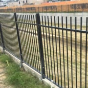 Steel security fencing on retaining wall
